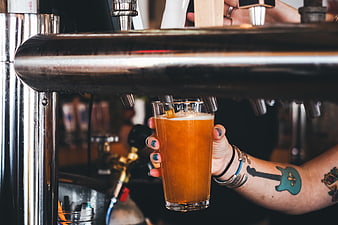 Tattooed Hand Pouring Craft Beer from Tap