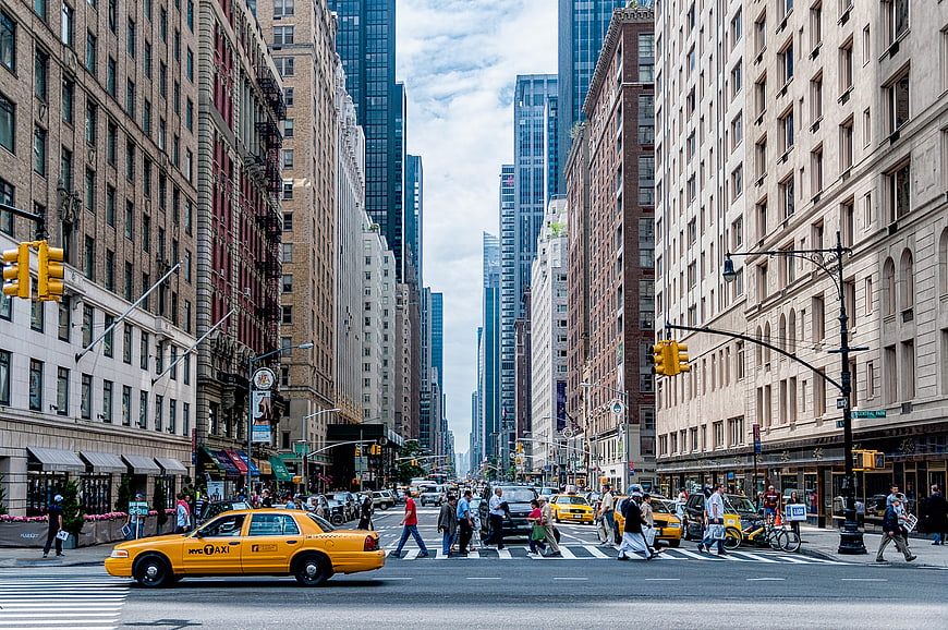 Busy New York City street with yellow taxi and pedestrians