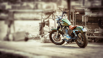 Vintage Green Motorcycle Parked at Rustic Dockside