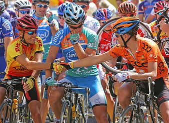 Cyclists shaking hands during a professional road race
