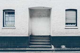 Minimalist white building facade with stairs and windows