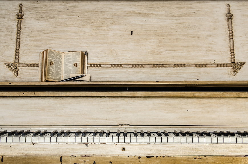 Vintage Piano with Open Sheet Music and Pen