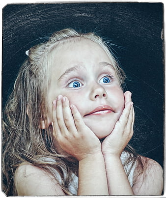 Portrait of a young blonde girl with blue eyes and hands on cheeks