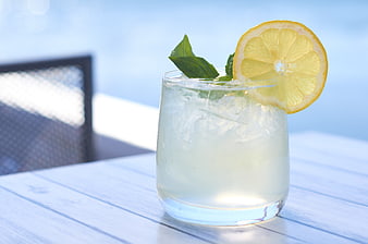 Refreshing Lemon Mojito Cocktail on White Table