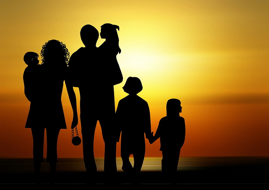 Silhouette of a family of five at sunset