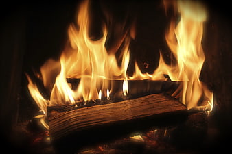 Close-up of burning logs in a fireplace with bright flames