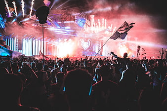 Vibrant Music Festival Crowd With Pyrotechnics And Stage Lights