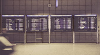 Airport Departure Board Display With Motion Blur Traveler