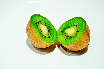 Fresh Kiwi Fruit Cut in Half on White Background
