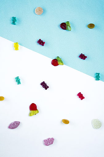 Colorful Gummy Bears and Candy on Split Blue and White Background