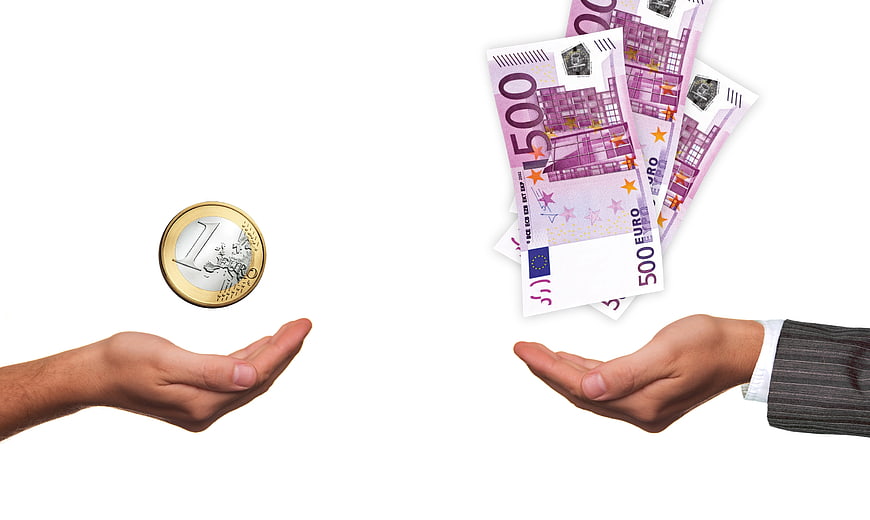 Concept of Wealth Inequality: Hands Holding Euro Coin and Banknotes