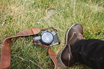 Vintage Canon Camera and Leather Boots in Green Grass