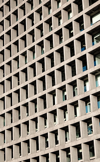 Modern Concrete Building Facade with Geometric Window Pattern