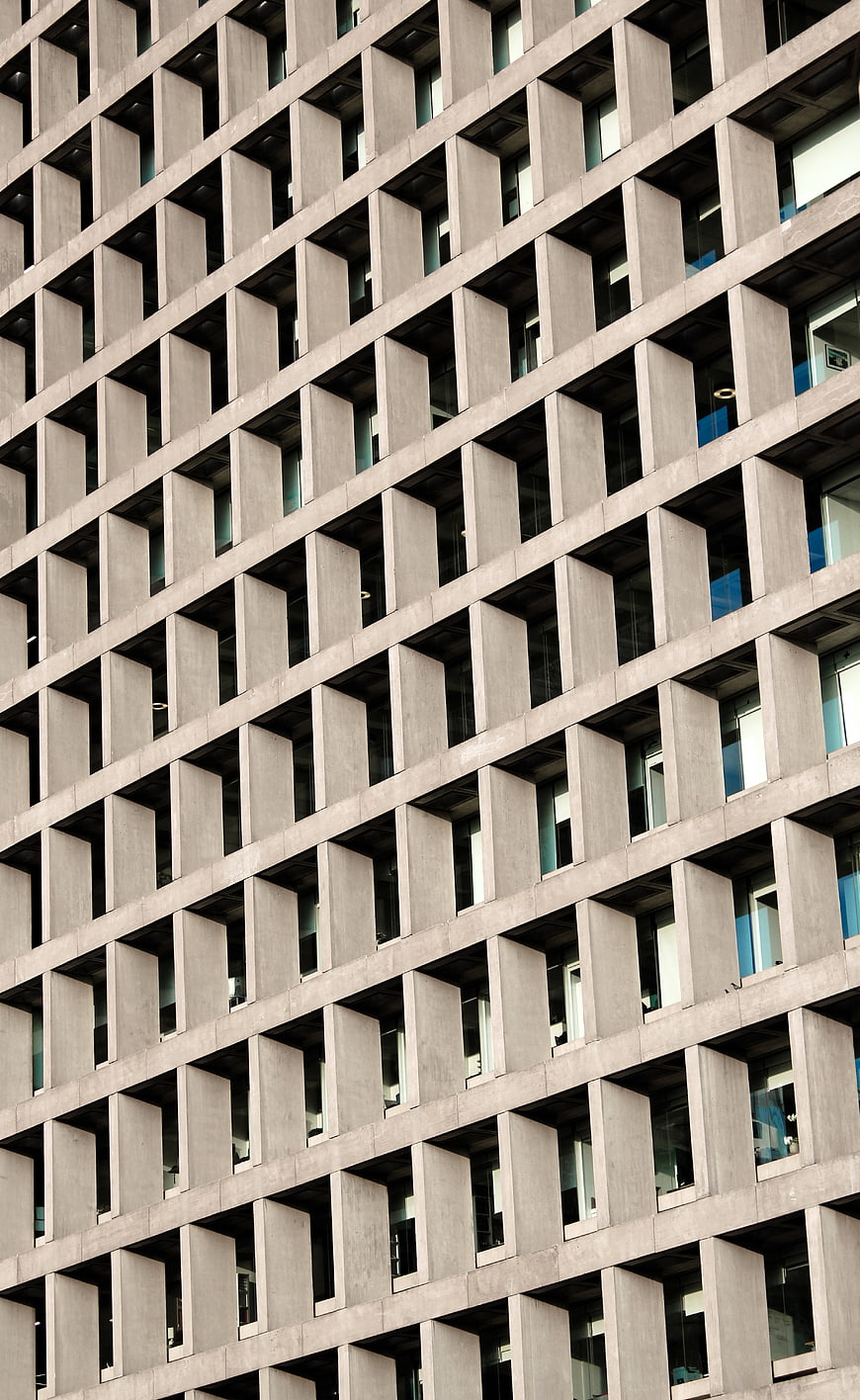 Modern Concrete Building Facade with Geometric Window Pattern