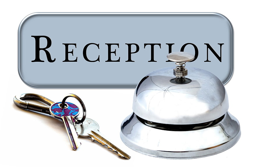 Hotel Reception Sign with Bell and Keys on White Background