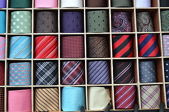 Assorted colorful silk ties in wooden display box