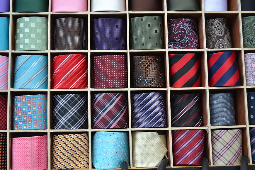 Assorted colorful silk ties in wooden display box