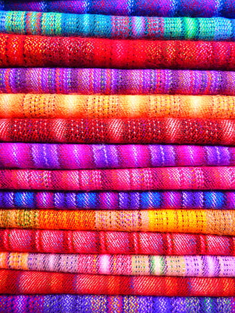 Vibrant Stacks of Multicolored Woven Textile Rolls