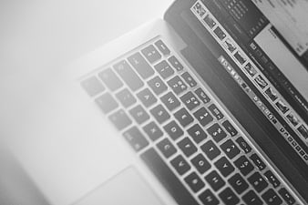 Black and White Close-Up of Laptop Keyboard and Screen
