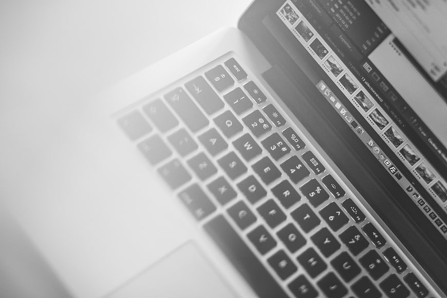 Black and White Close-Up of Laptop Keyboard and Screen