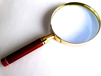 Elegant wooden handle magnifying glass with gold rim on white background