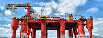 Red offshore oil platform named Borgholm Dolphin against blue sky