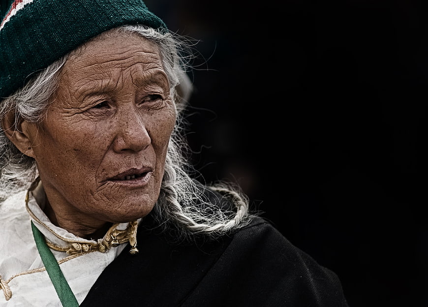 Portrait of elderly Tibetan woman with traditional attire