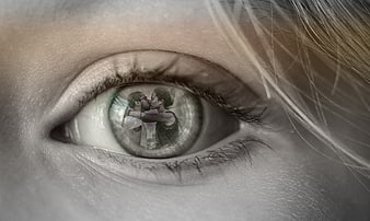 Close-up of eye with couple kissing reflection in iris