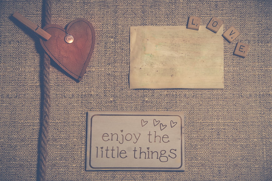 Vintage rustic flat lay with heart, rope, and inspirational quote