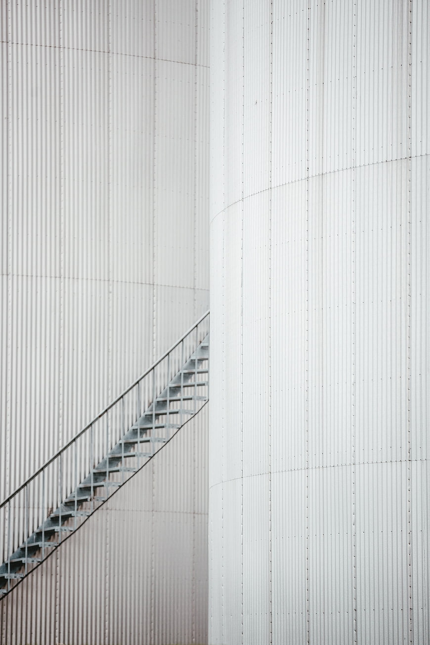 Abstract White Industrial Tank with Metal Staircase