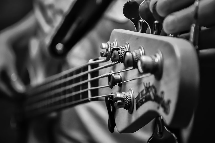Close-up of Electric Bass Guitar Headstock Tuning Pegs