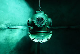 Vintage Brass Diving Helmet Hanging in Dark Teal Atmosphere