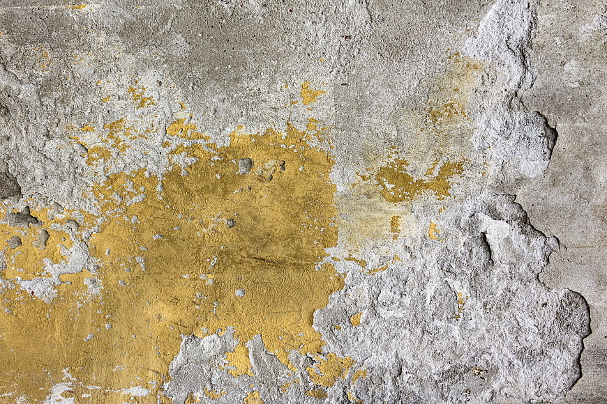 Textured Concrete Wall with Peeling Yellow Paint
