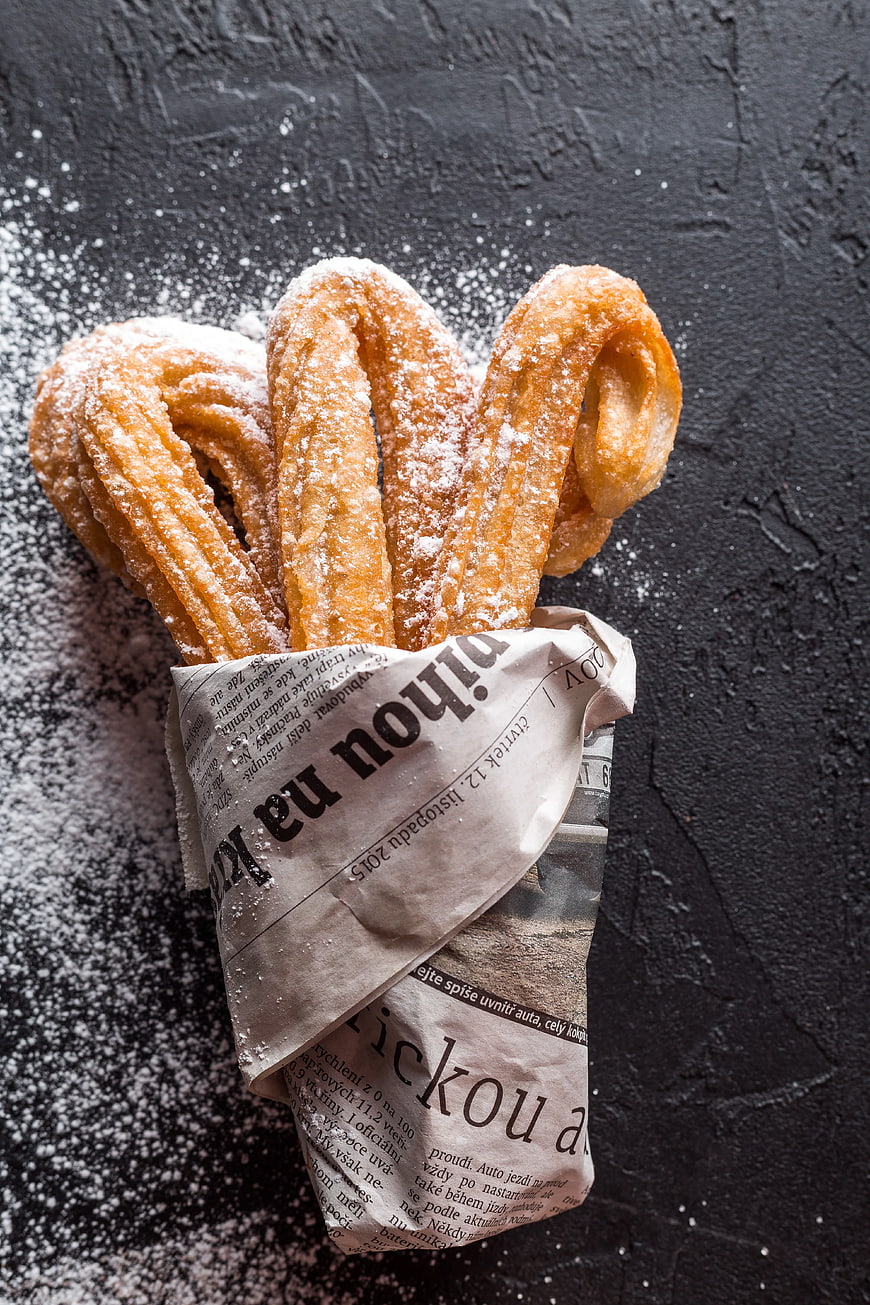 Traditional Spanish Churros Wrapped in Newspaper