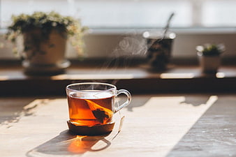 Steaming Cup of Hot Tea on Wooden Table