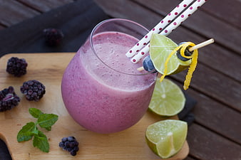 Pink Berry Smoothie With Lime Garnish And Polka Dot Straws