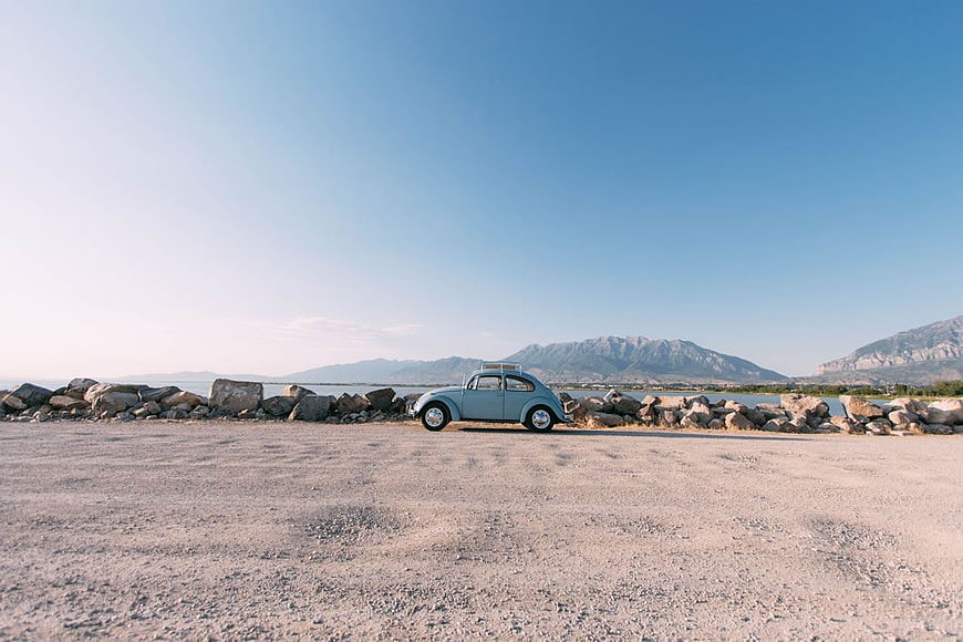 Vintage Blue Volkswagen Beetle Parked by the Sea