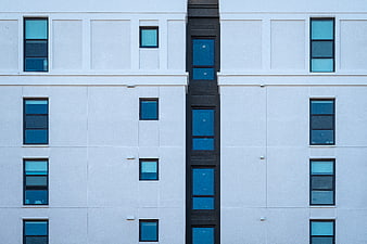 Modern White Apartment Building Facade with Blue Windows