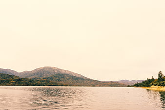 Serene Lake Landscape with Mountains and Autumn Foliage