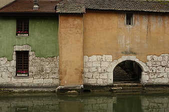Old European canal houses with stone walls and flower boxes