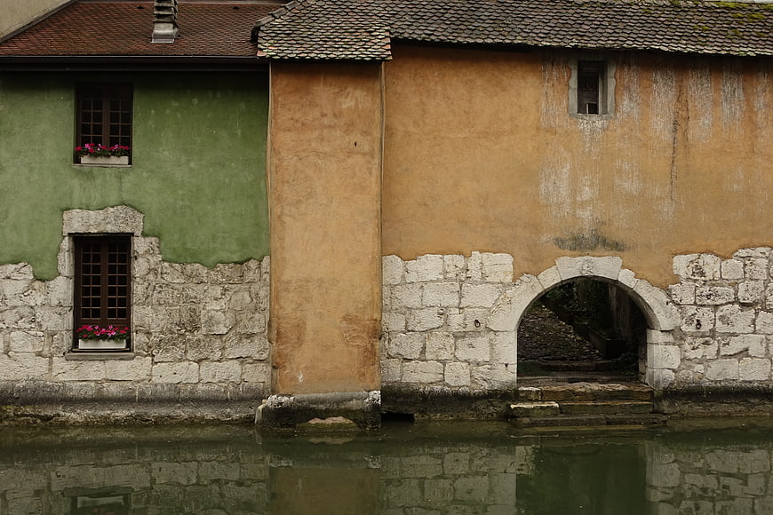 Old European canal houses with stone walls and flower boxes
