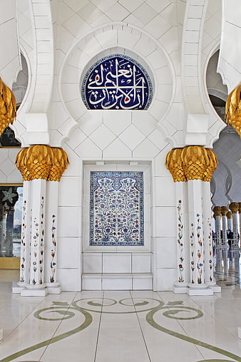 Interior of Sheikh Zayed Grand Mosque with gold columns and calligraphy