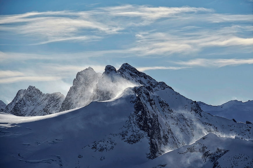 Majestic Snow-Capped Mountain Peak with Wind-Blown Snow