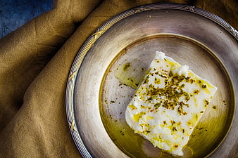 Feta cheese with olive oil and oregano on silver plate