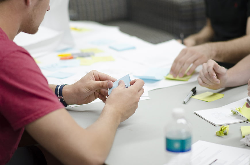 Team brainstorming with sticky notes in office meeting