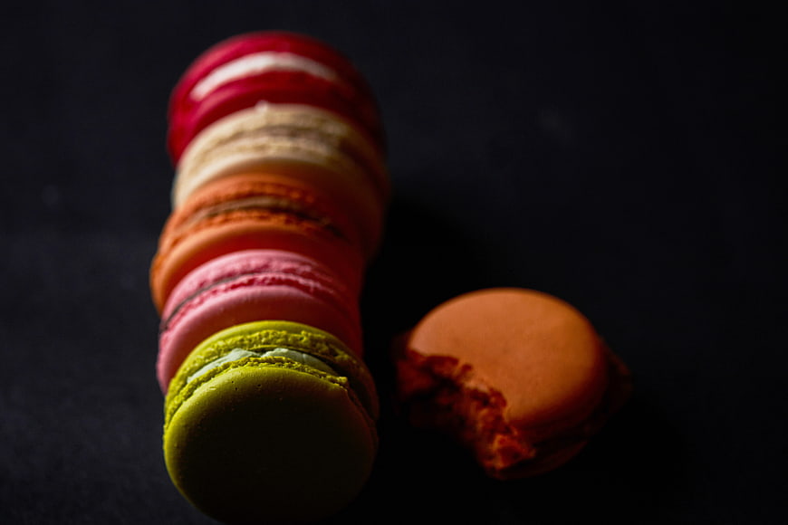 Stack of Colorful French Macarons on Dark Background