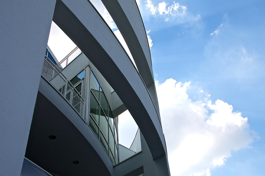Modern White Curved Architecture Against Blue Sky