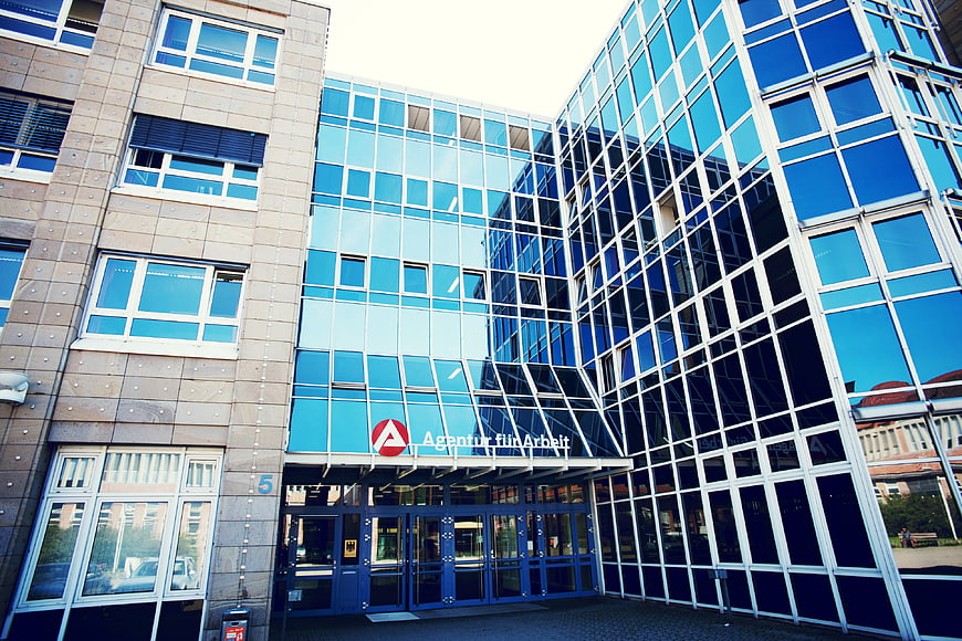 Modern Glass Office Building with Employment Agency Signage