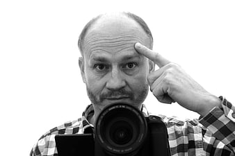 Black and white portrait of a male photographer holding a camera