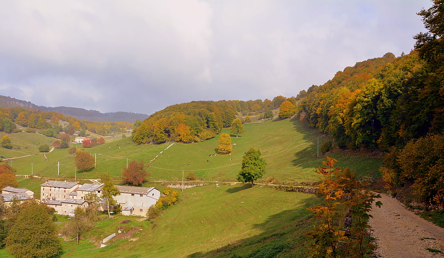 Autumnal Italian countryside landscape with rolling green hills and village